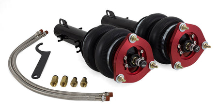 2 vehicle air suspension struts with black double bellow air bags and red accented camber plates, 2 stainless steel braided air hoses, adjustment tool and 4 fittings.