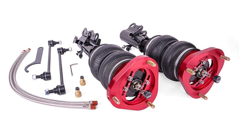 Red and black Air Lift Performance front suspension struts with air bags, 2 leader lines and fittings.